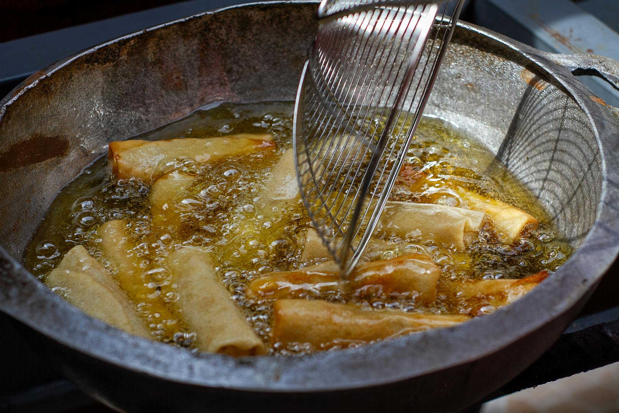 Home Close Up Of Spring Rolls Frying In Hot Oil Showcasing Texture And Heat Bubbles. 29037271 2048x1365