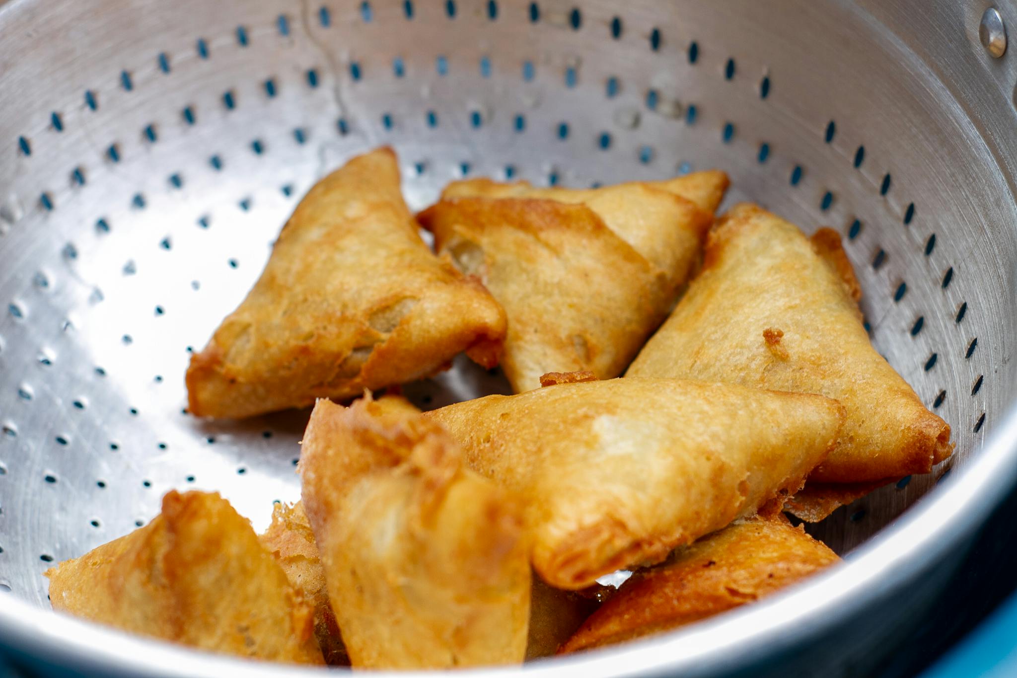 Home Crispy Golden Fried Samosas Placed In A Stainless Colander Perfect For A Savory Snack. 29037265 2048x1365