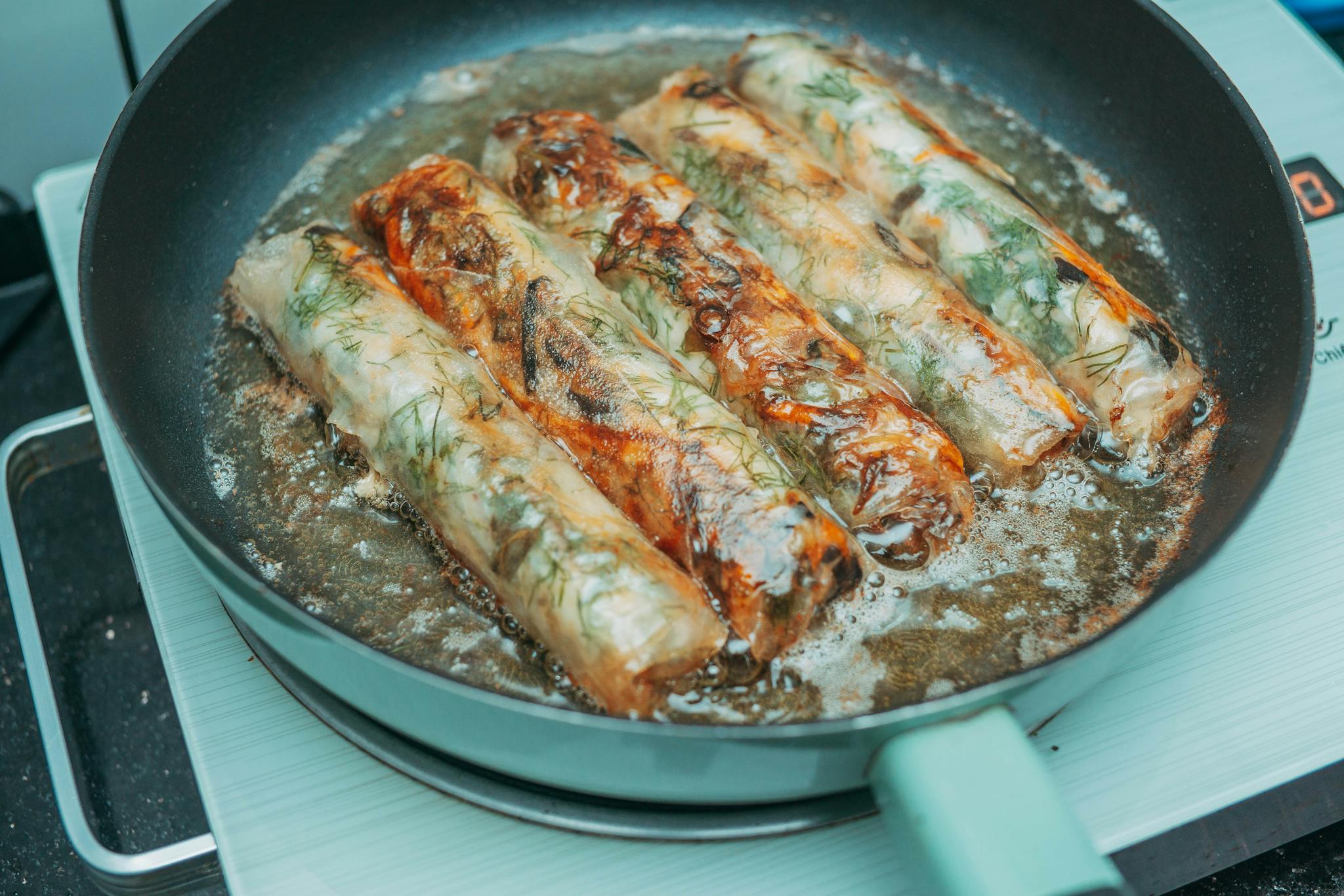 Delicious Fried Spring Rolls Sizzling In A Pan Over A Stove Crispy And Golden Brown. 36752864 2048x1365